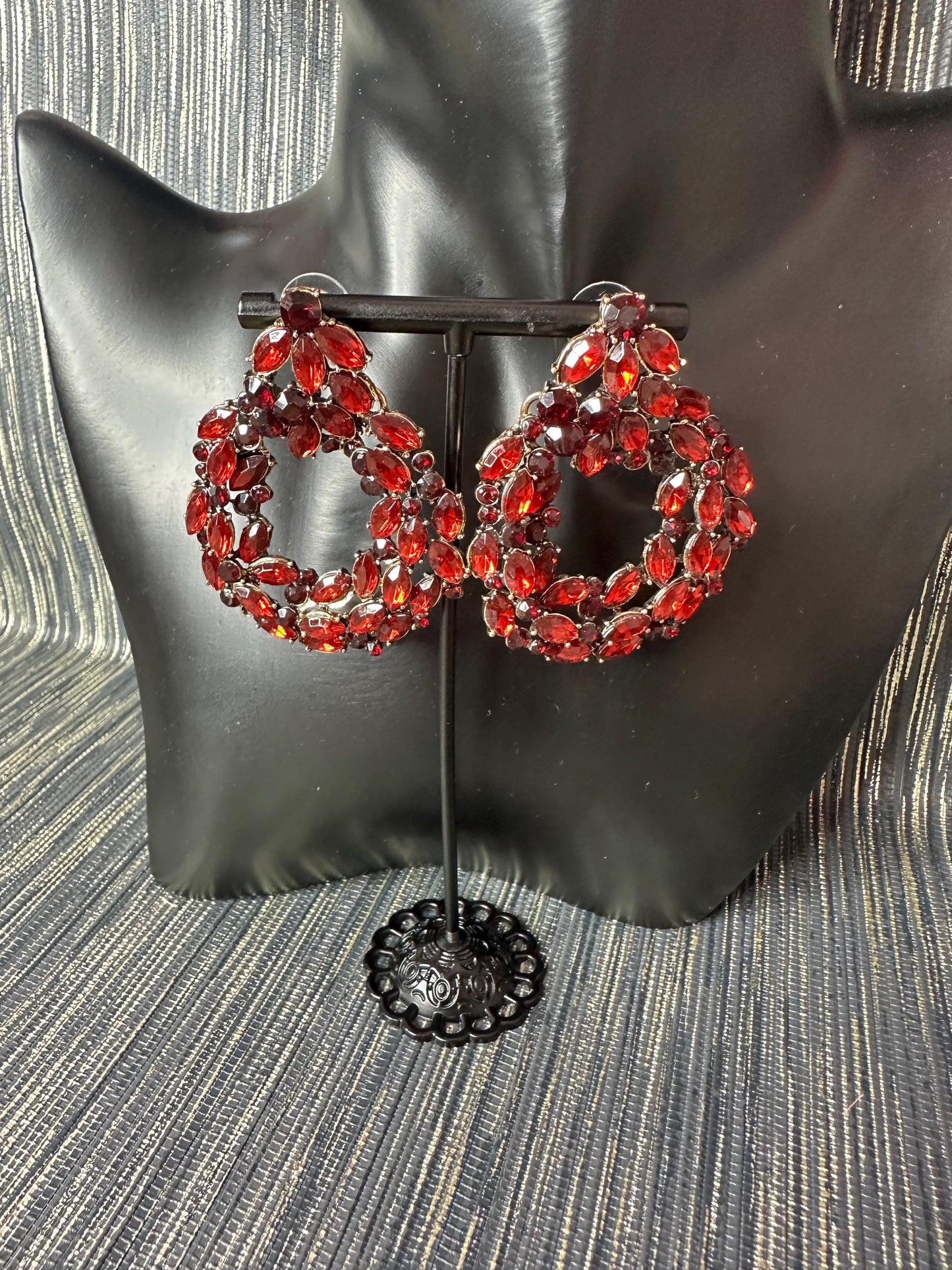 Roundish red stoned earrings.