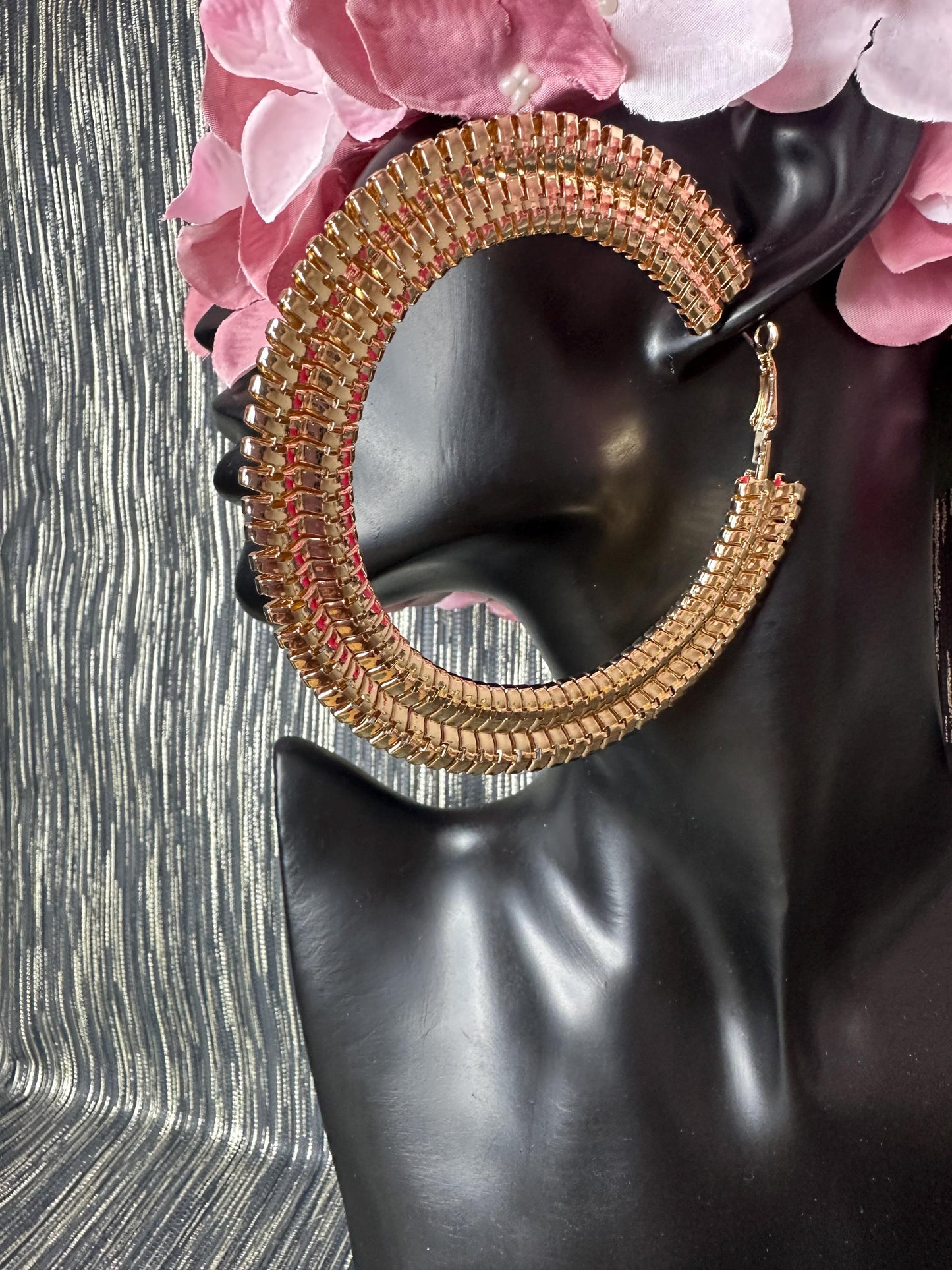 Large Patterned gold hoop earrings.