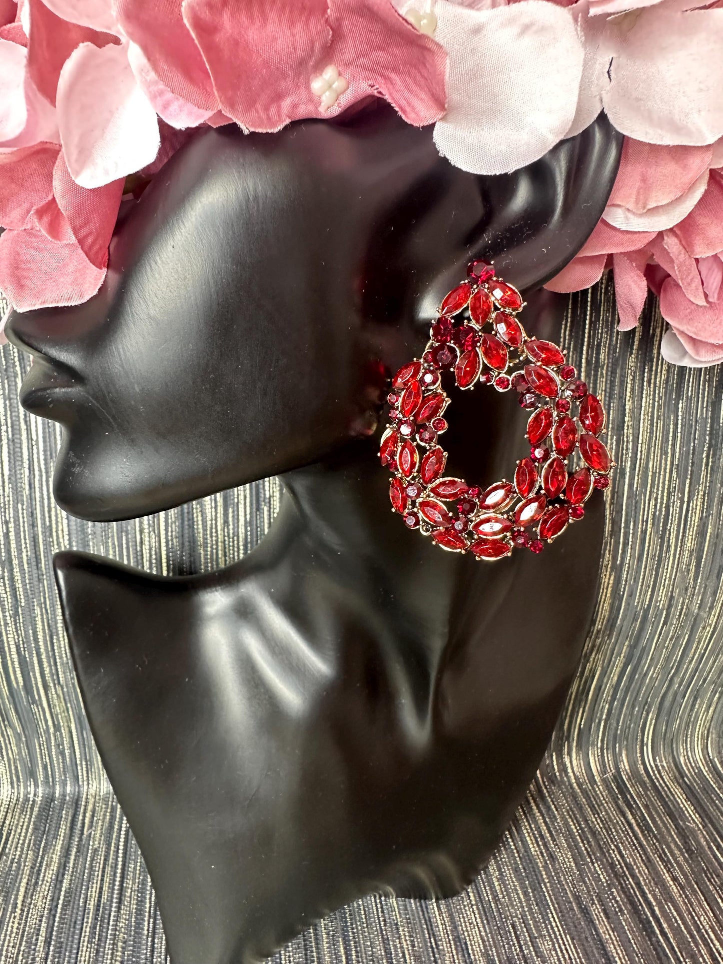 Roundish red stoned earrings.