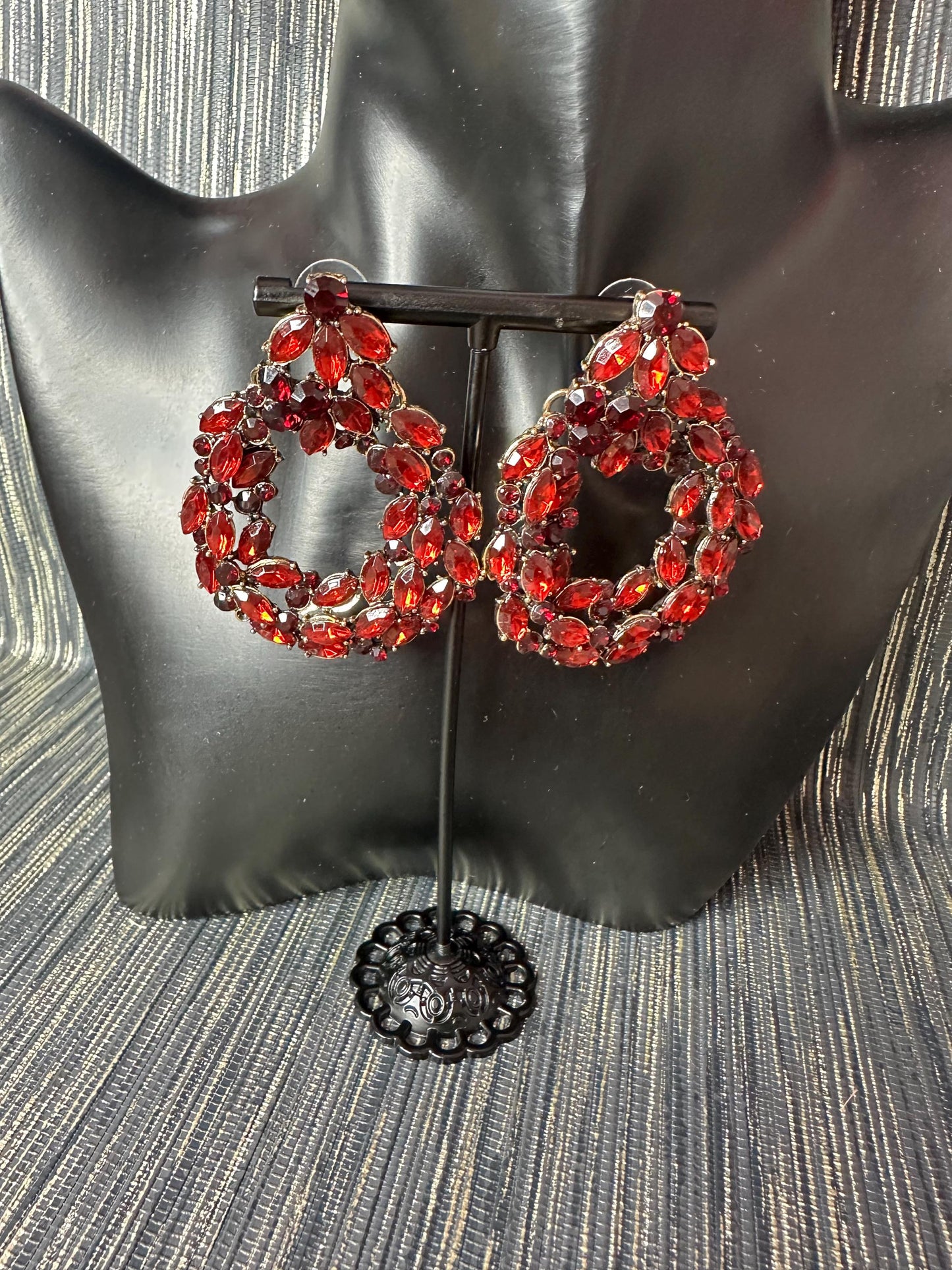 Roundish red stoned earrings.